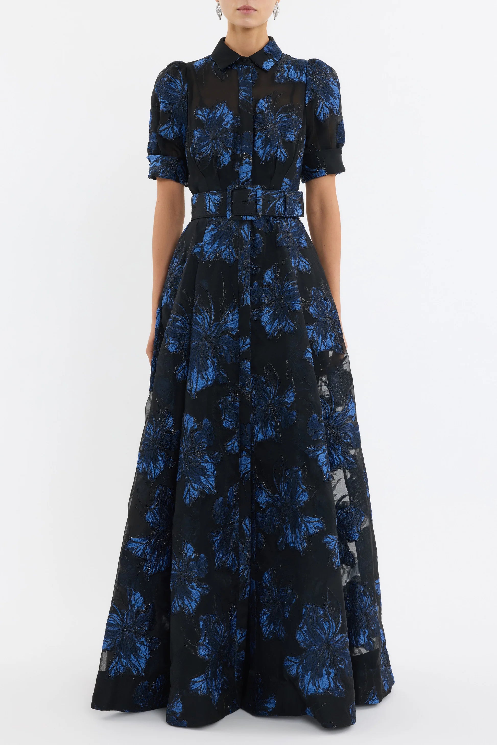 Woman wearing a black and blue floral dress on a white background