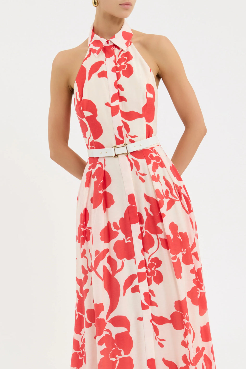 Woman wearing a red floral dress on a white background