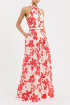 Woman wearing a red floral dress on a white background