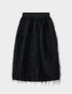 A midi-length, high-waist black balloon skirt with fringe detailing and a zip and hook closure at the back. The skirt has a regular fit and side pockets.