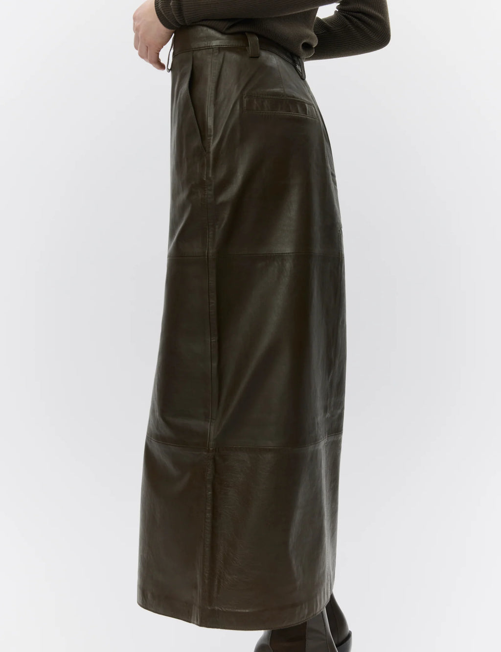 Brown leather skirt worn by a person on a white background