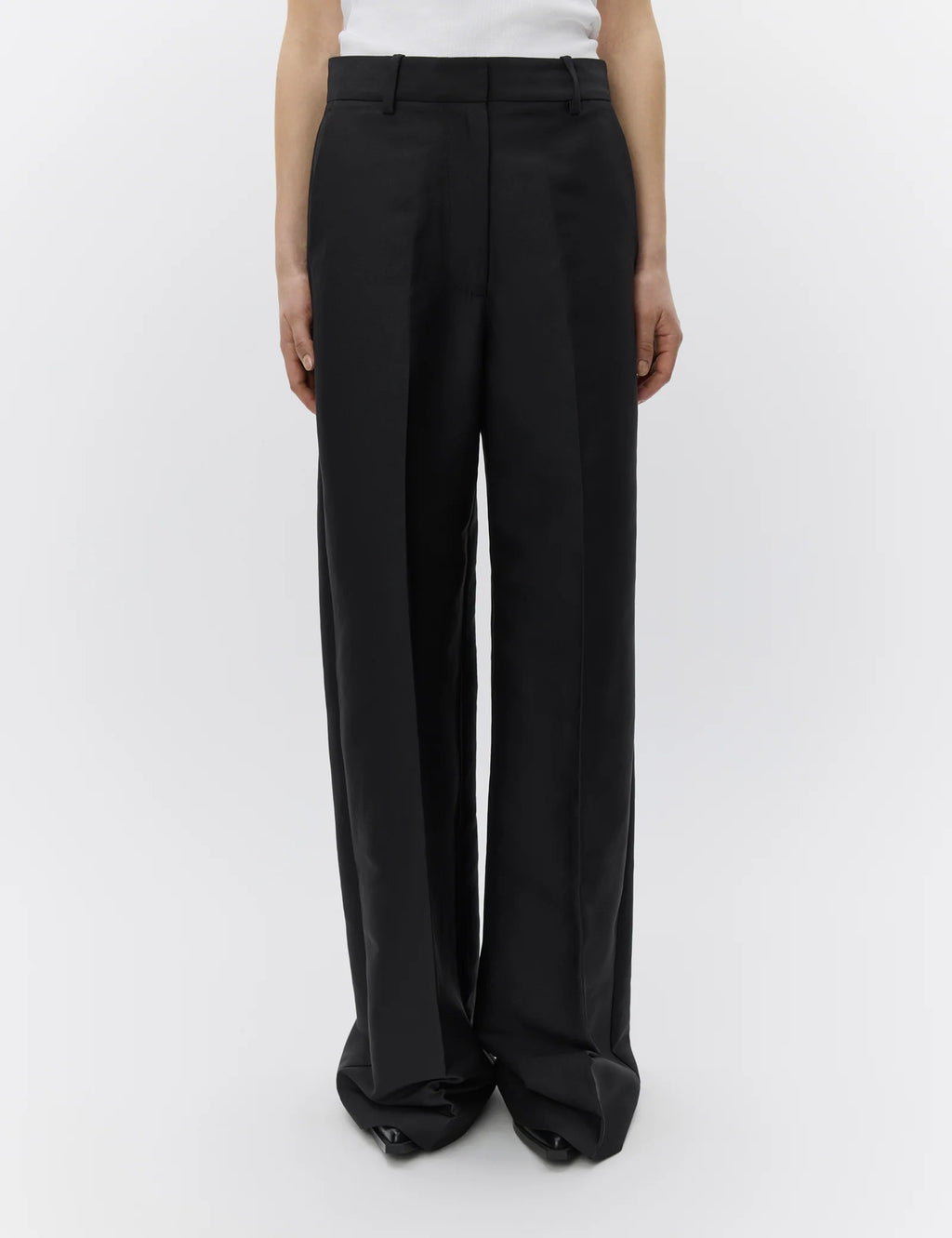 Black wide-leg pants worn by a person on a white background