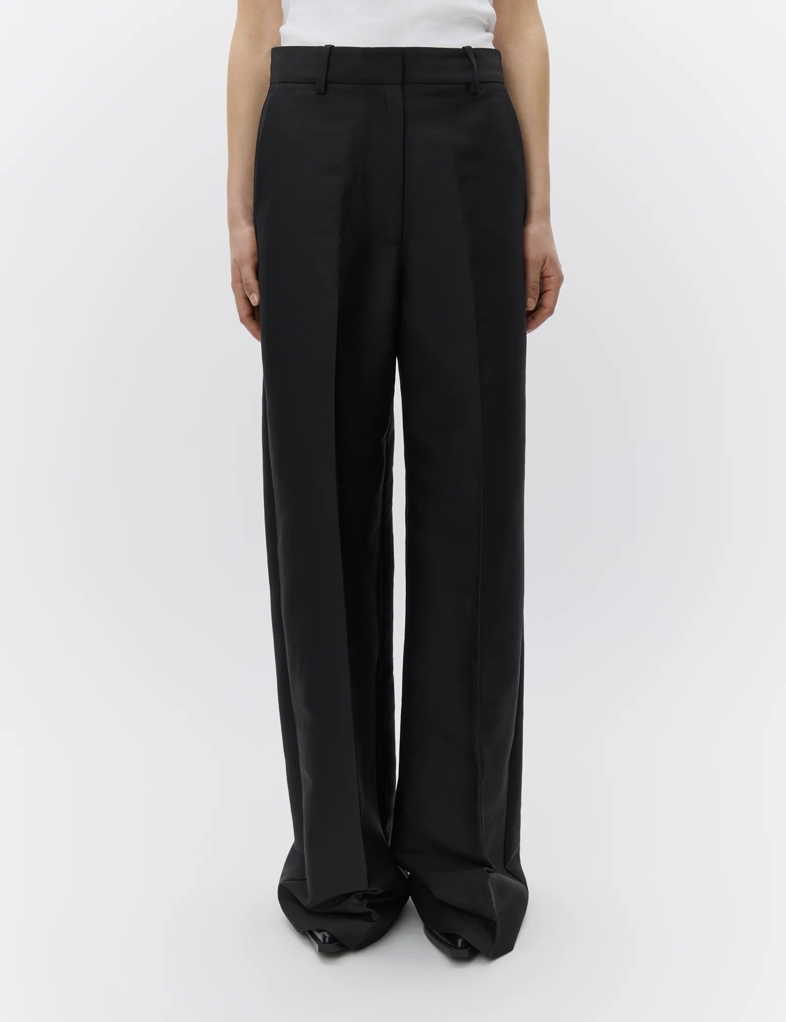 Black wide-leg pants worn by a person on a white background