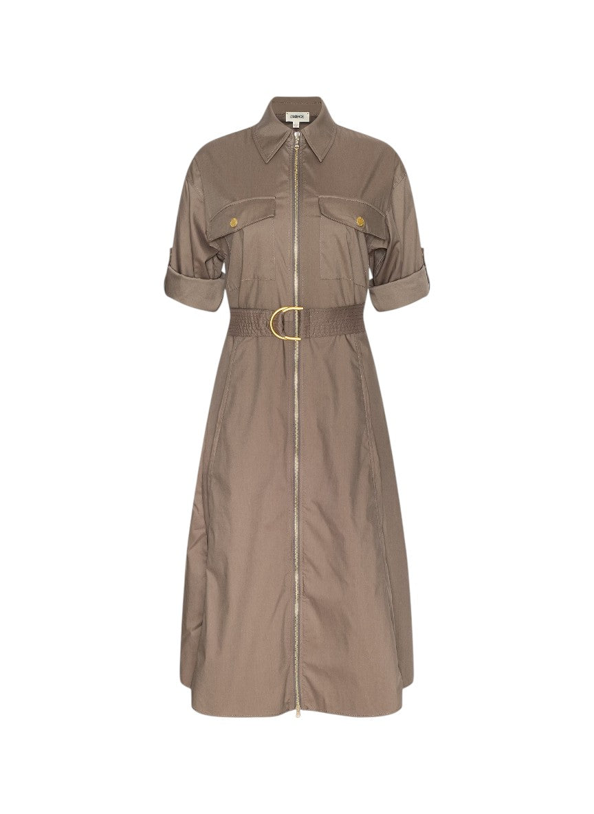 A taupe-brown utility shirt dress with a front zipper, collar, chest flap pockets, rolled sleeves, and a matching waist belt with a gold buckle, shown on a plain white background.