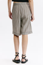 Person wearing striped shorts on a white background