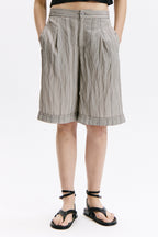 Person wearing striped shorts on a white background