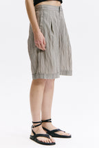 Person wearing a striped skirt on a white background