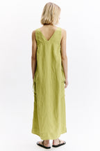 Woman wearing a light green dress on a white background