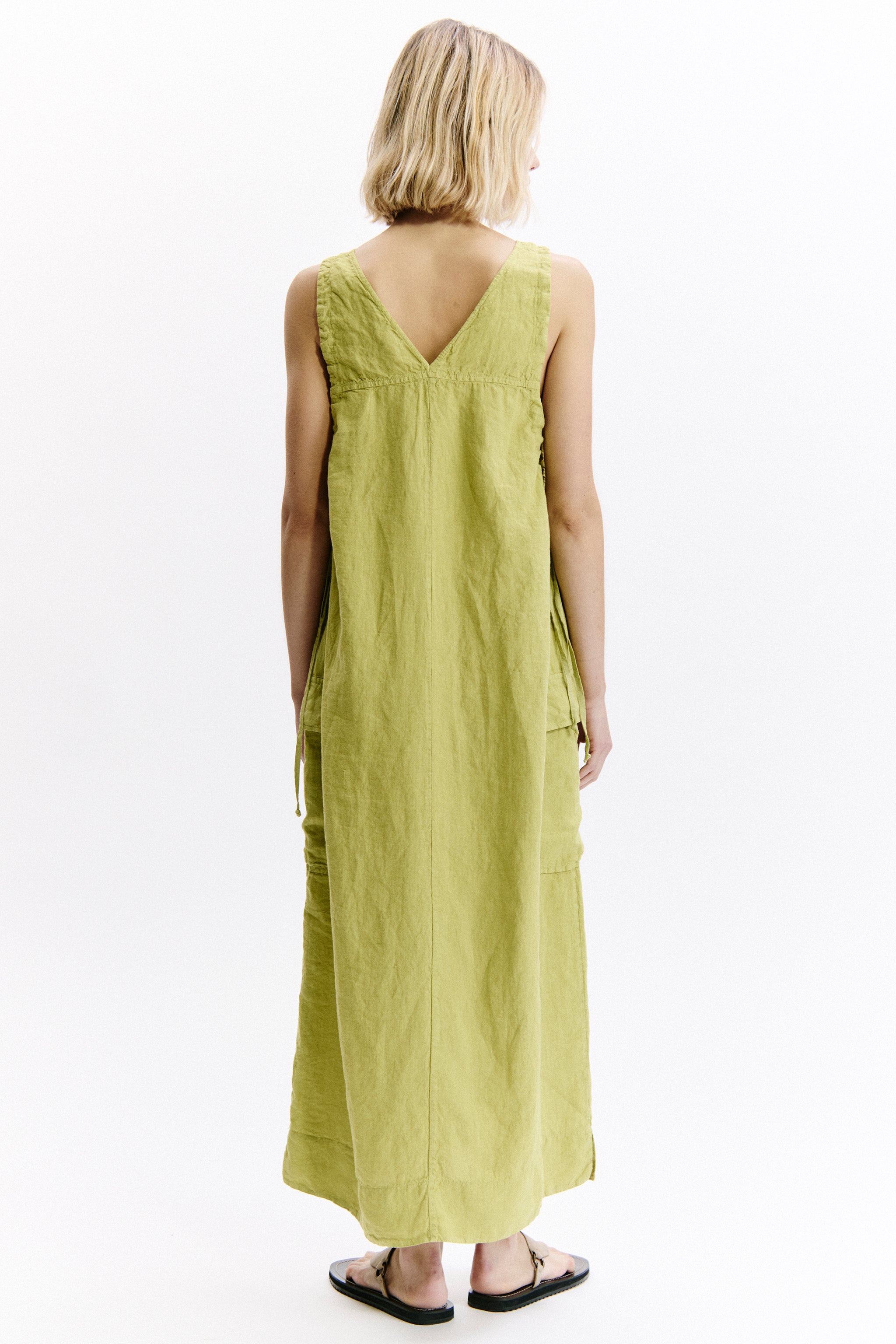 Woman wearing a light green dress on a white background