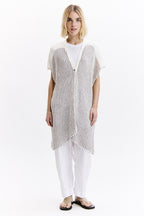 Woman wearing a black and white striped vest over a white shirt on a white background