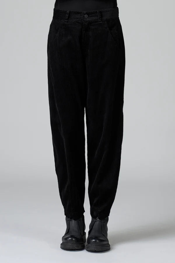 Black pants worn by a person on a white background