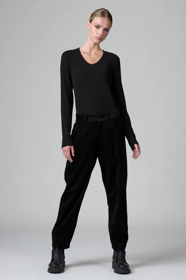 Model wearing a black outfit on a gray background