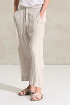 Transit pants with a soft fit, slightly arched leg and pockets on the side with flaps on the front and welt on the back. Garment made of linen and cupro fabric with micro pattern.