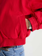 Red jacket worn by a person on a light gray background
