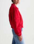Person wearing a red shirt and blue jeans on a white background