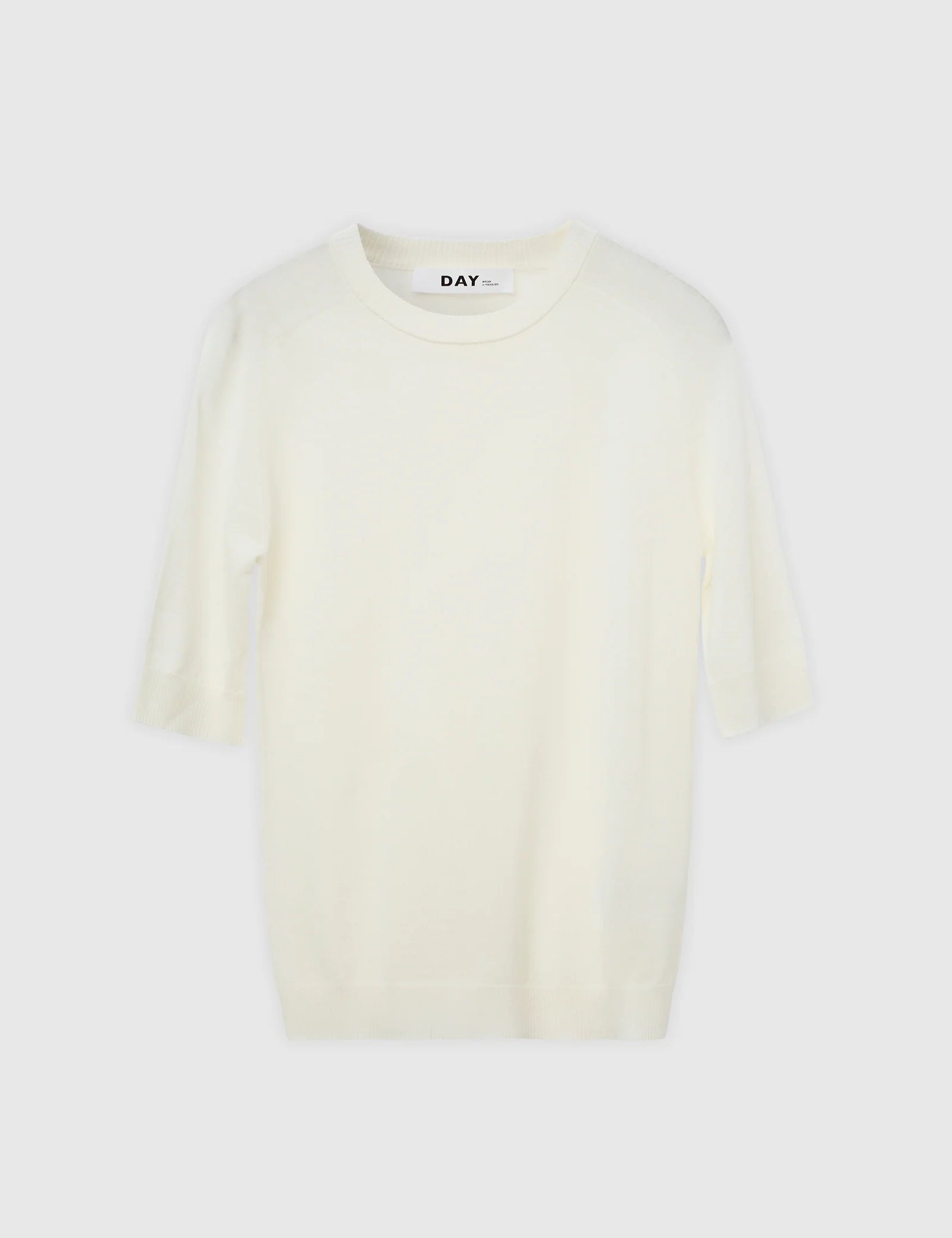 White t-shirt with 'DAY' branding on a white background