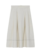White skirt with a subtle pattern on a light gray background
