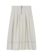 White skirt with a subtle pattern on a light gray background