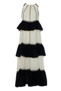 Black and white tiered dress with decorative elements on a white background