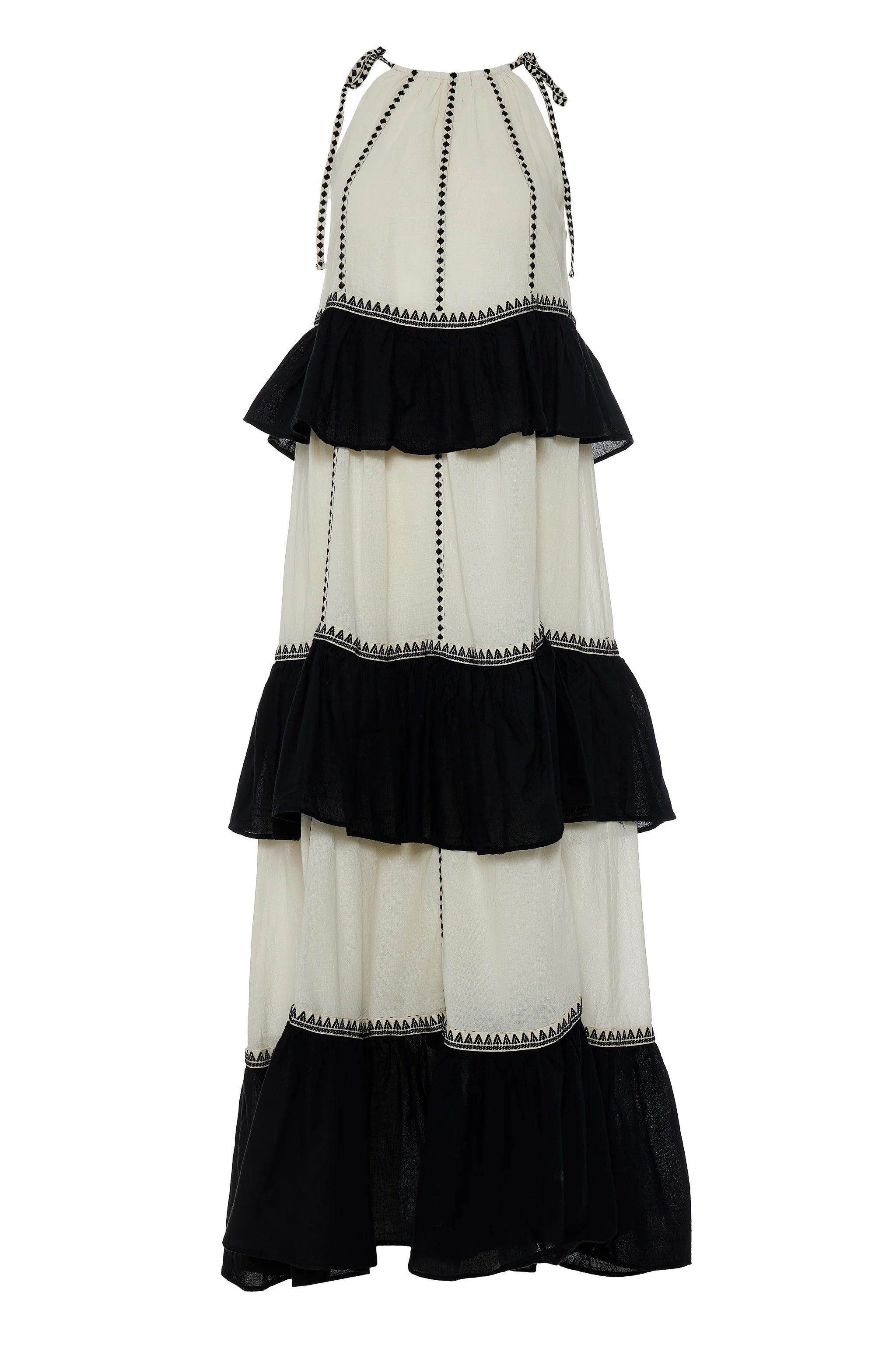 Black and white tiered dress with decorative elements on a white background