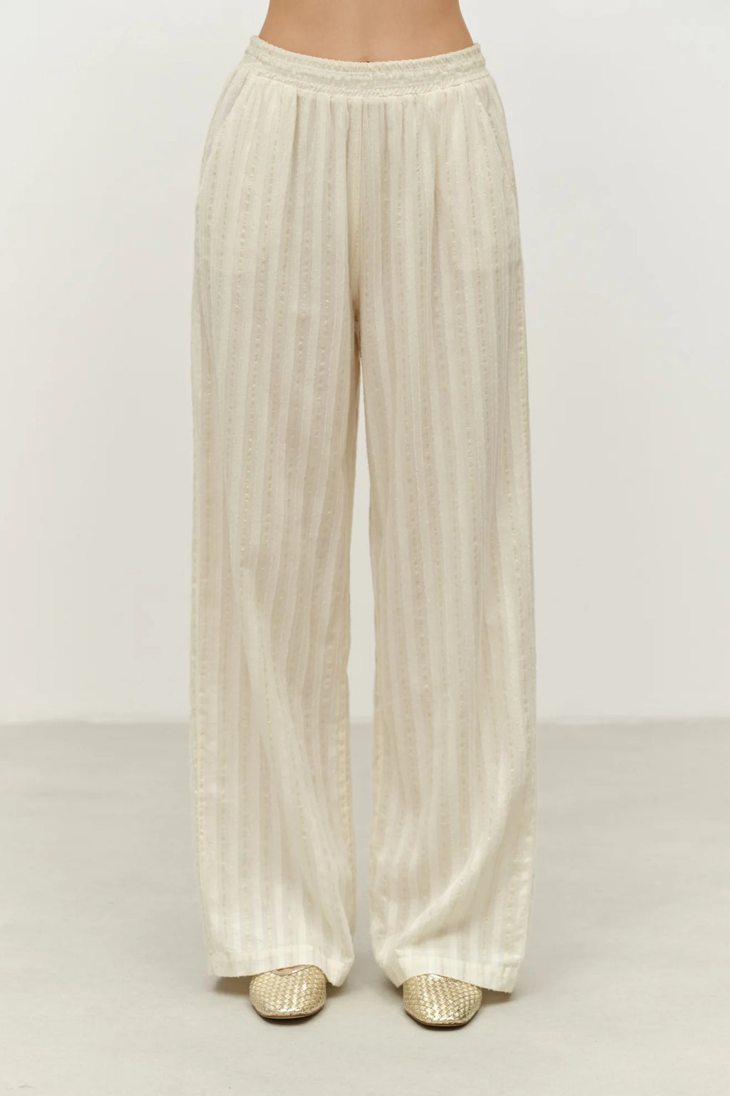 Beige wide-leg pants on a plain background
