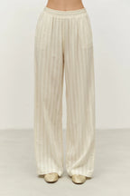 Beige wide-leg pants on a plain background