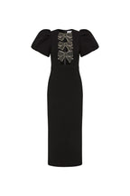 A Rebecca vallance black midi dress with puff sleeves, beaded bow embellishments, and a fitted bodice with front cutouts. It features a pencil skirt with a back split and a zip fastening at the back.