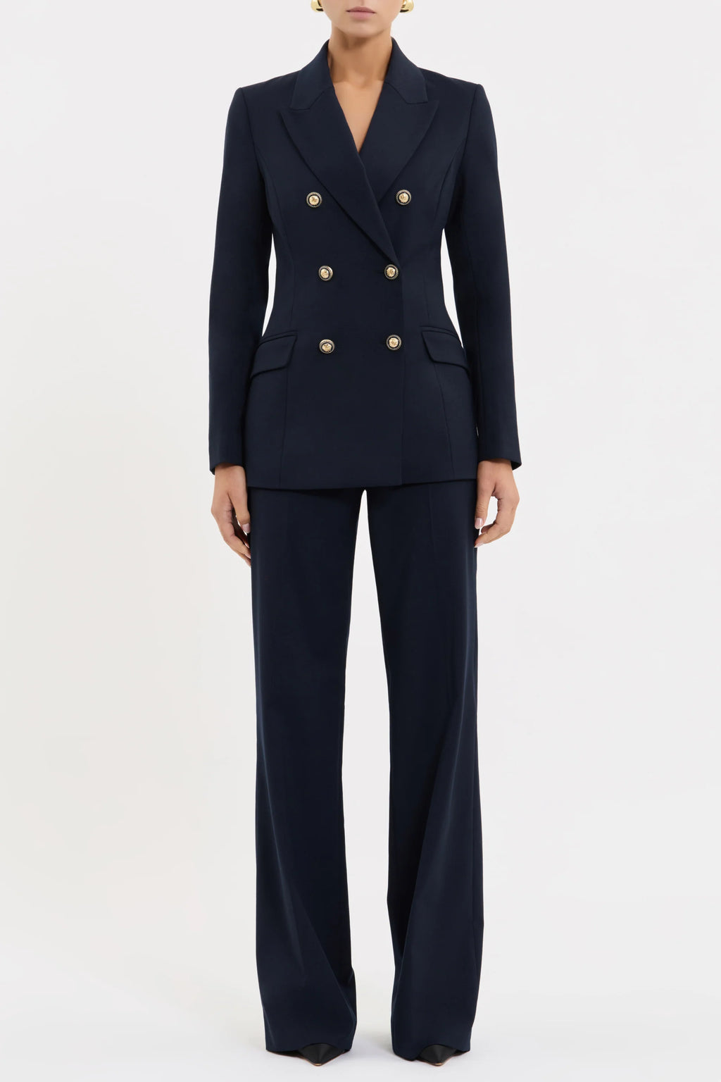 Navy blue suit with gold buttons on a white background