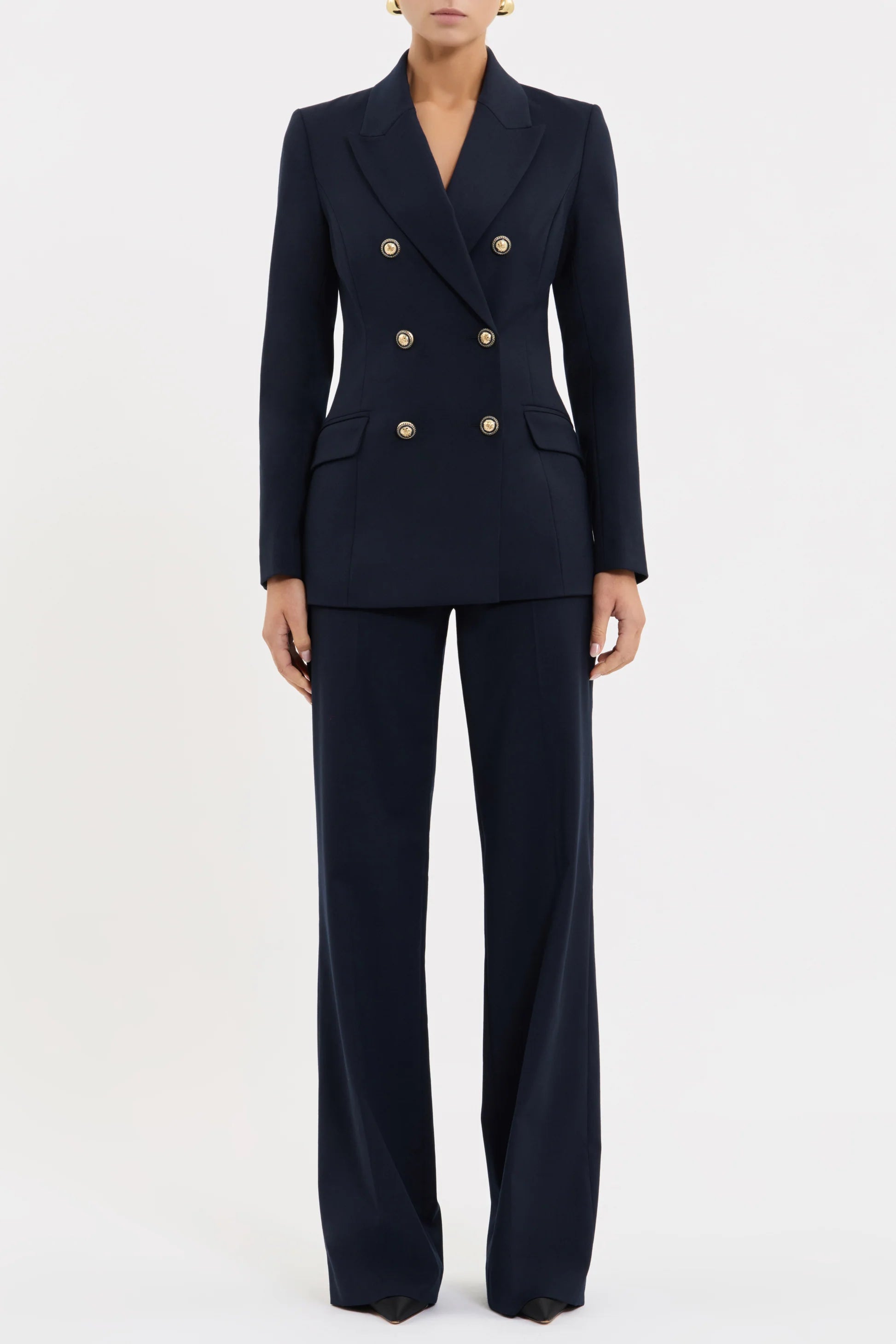Navy blue suit with gold buttons on a white background