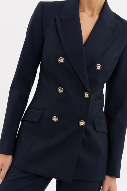 Navy blue double-breasted blazer with gold buttons on a white background