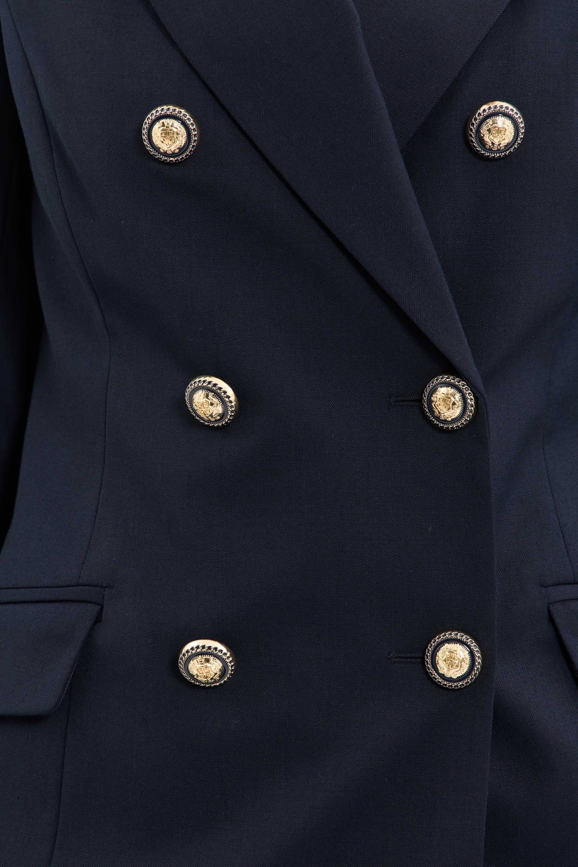 Close-up of a navy blue blazer with gold buttons