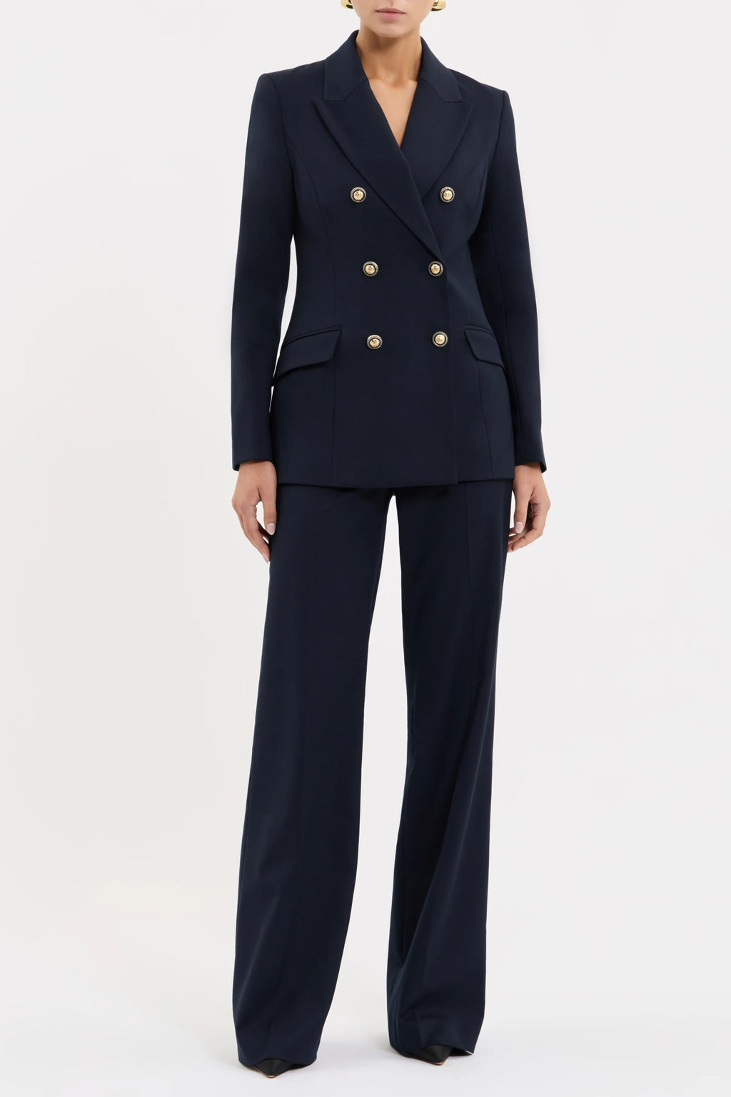 Navy blue suit with gold buttons on a white background