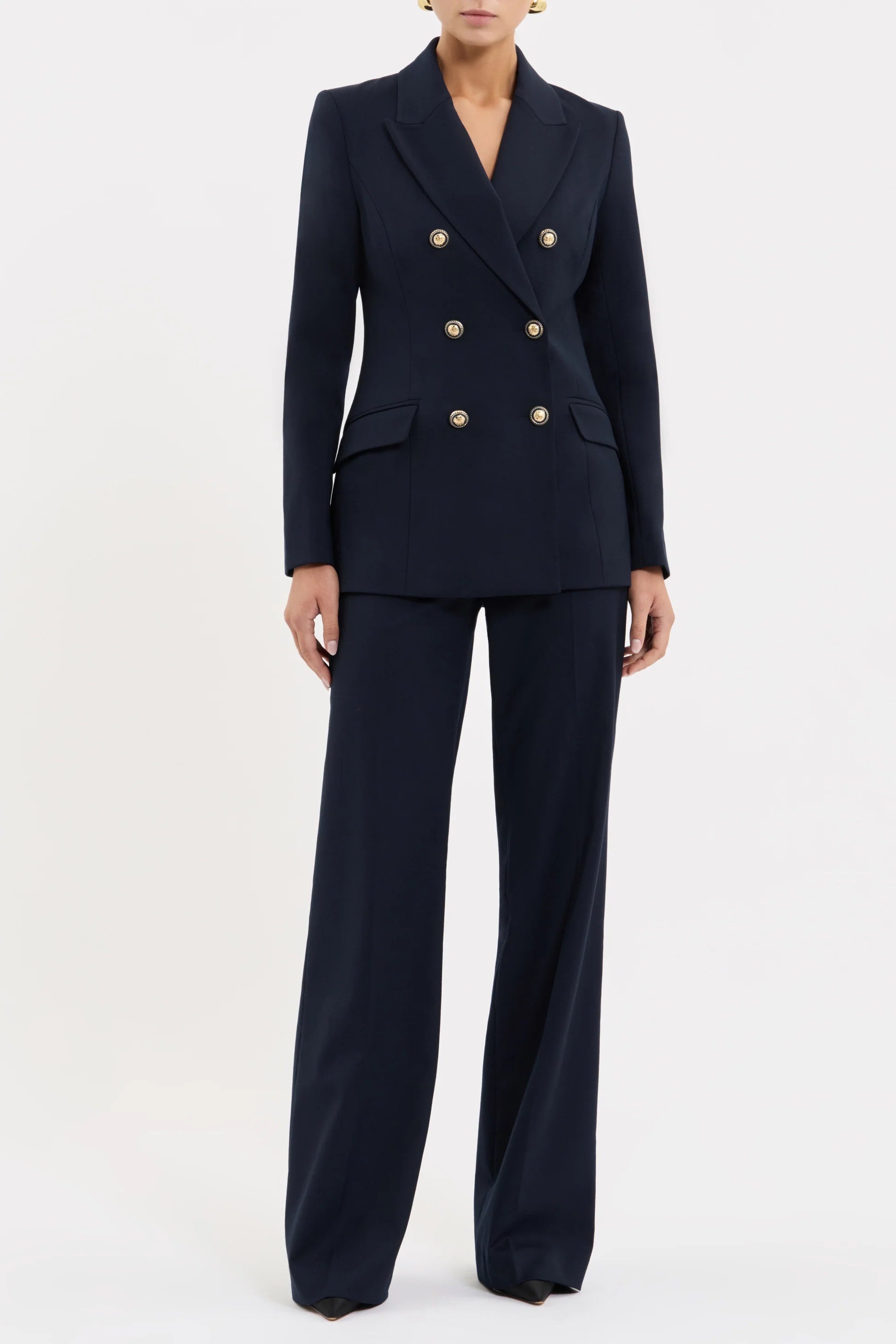 Navy blue suit with gold buttons on a white background