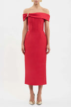 A model wearing a bright red off-the-shoulder midi dress with a structured corset-style bodice and a gold zipper detail at the neckline, paired with gold pointed-toe heels against a plain white studio background.