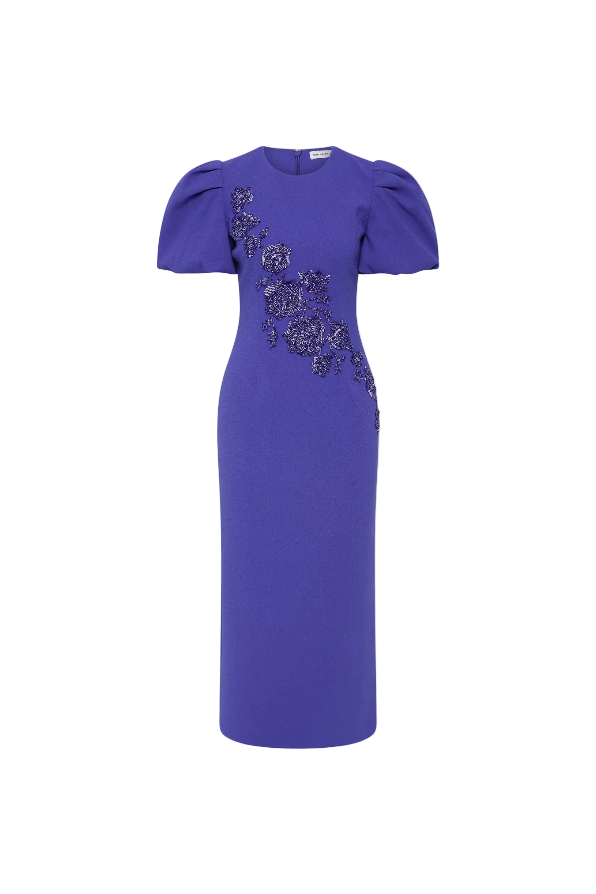The Rebecca Vallance Evolet Puff Sleeve Midi Dress is captivating in a vibrant ultra marine blue, adorned with intricate floral embellishments. Tailored from bonded crepe, its crew neckline and voluminous short puff sleeves create a refined and elegant shape, complemented by a fitted bodice that flatters the figure. The pencil midi skirt creates an elegant silhouette, detailed with a back split for ease of movement. Secured with an invisible zip fastening at the back and lining for comfort, this dress is a 