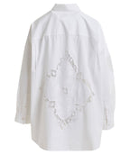 White blouse with intricate beaded design on a white background