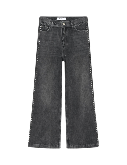 Black jeans with studded details on a white background