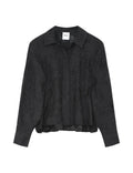 Black textured shirt on a light gray background