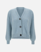 A light blue, long-sleeved cardigan with a V-neckline and ribbed hems, featuring contrasting maxi buttons.
