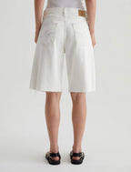 Person wearing white shorts on a plain background