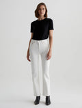 A woman standing straight facing forward, wearing a black t-shirt and mid-rise straight white jeans with visible five pockets, paired with black ankle boots.