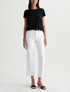 Person wearing a black t-shirt and white pants on a white background