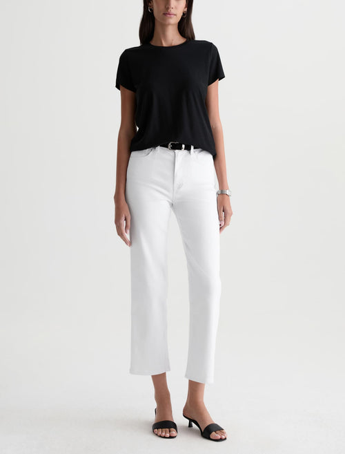 Person wearing a black t-shirt and white pants on a white background