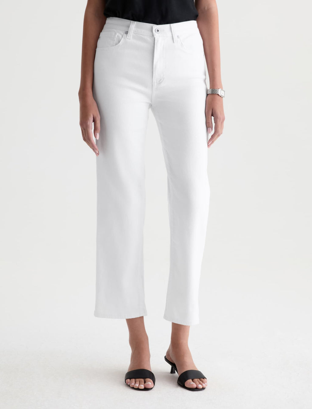 Person wearing white pants on a plain background