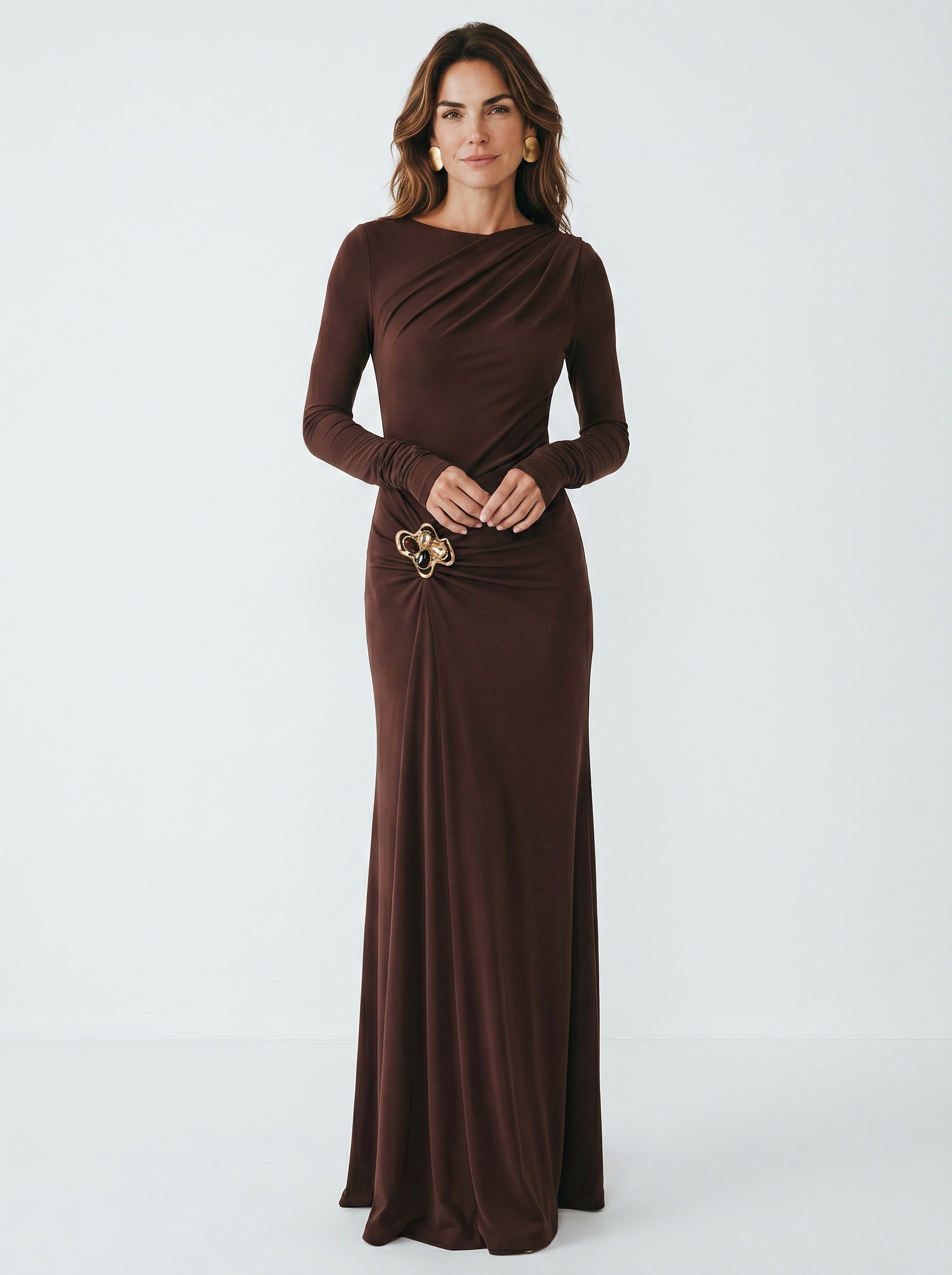 Woman wearing a brown evening gown with a belt on a white background