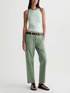 A model wearing sage green wide-leg cropped pants with a black belt, paired with a light mint green ribbed tank top and black sandals, against a plain white studio background.