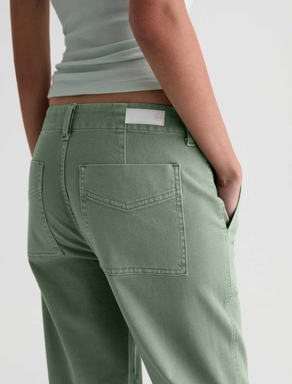 Person wearing green pants on a plain background