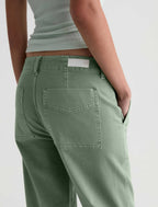 Person wearing green pants on a plain background