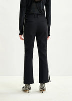 Person wearing black high-waisted pants with a white background