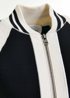 Close-up of a black and white jacket with a zipper on a white background
